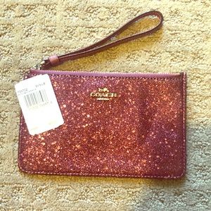 Pink coach clutch